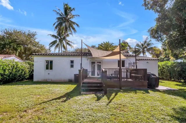 a house view with swimming pool in front of it