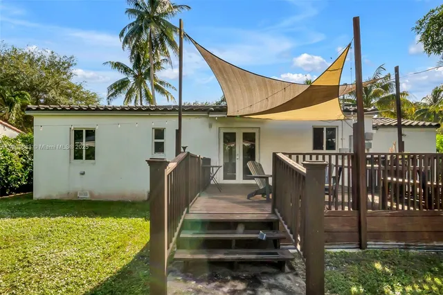 a view of a house with a yard and furniture