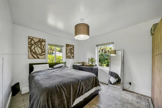 a spacious bedroom with a bed and a window