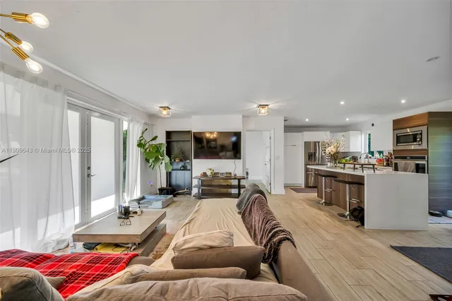 a bedroom with furniture and a large window
