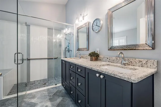 a bathroom with a granite countertop sink a toilet and a large mirror
