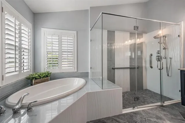 a dining room with furniture and a floor to ceiling window