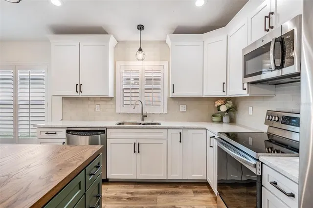 a view of a dining room with furniture wooden floor and chandelier