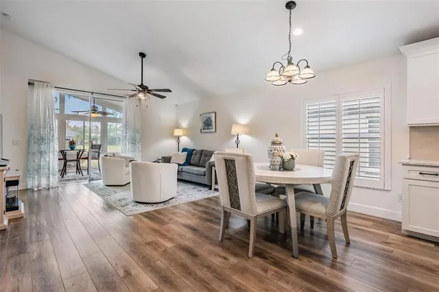 a living room with furniture and view of kitchen