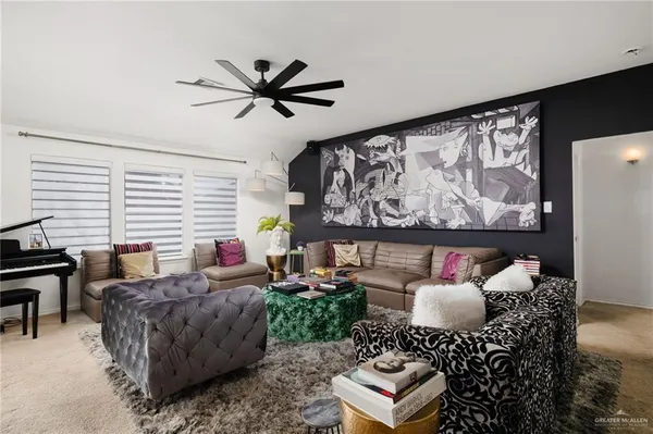 a dining room with furniture potted plants and wooden floor