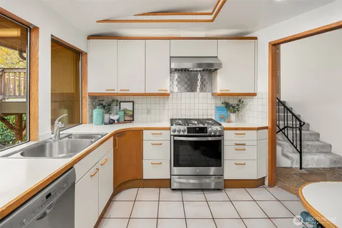 a kitchen with a stove a sink and a refrigerator
