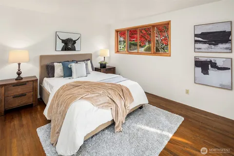 a bedroom with a bed and a night stand