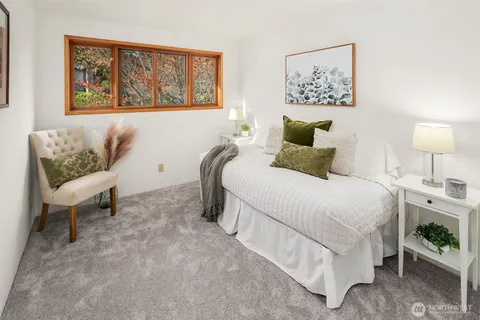 a bedroom with a bed and a painting on the wall