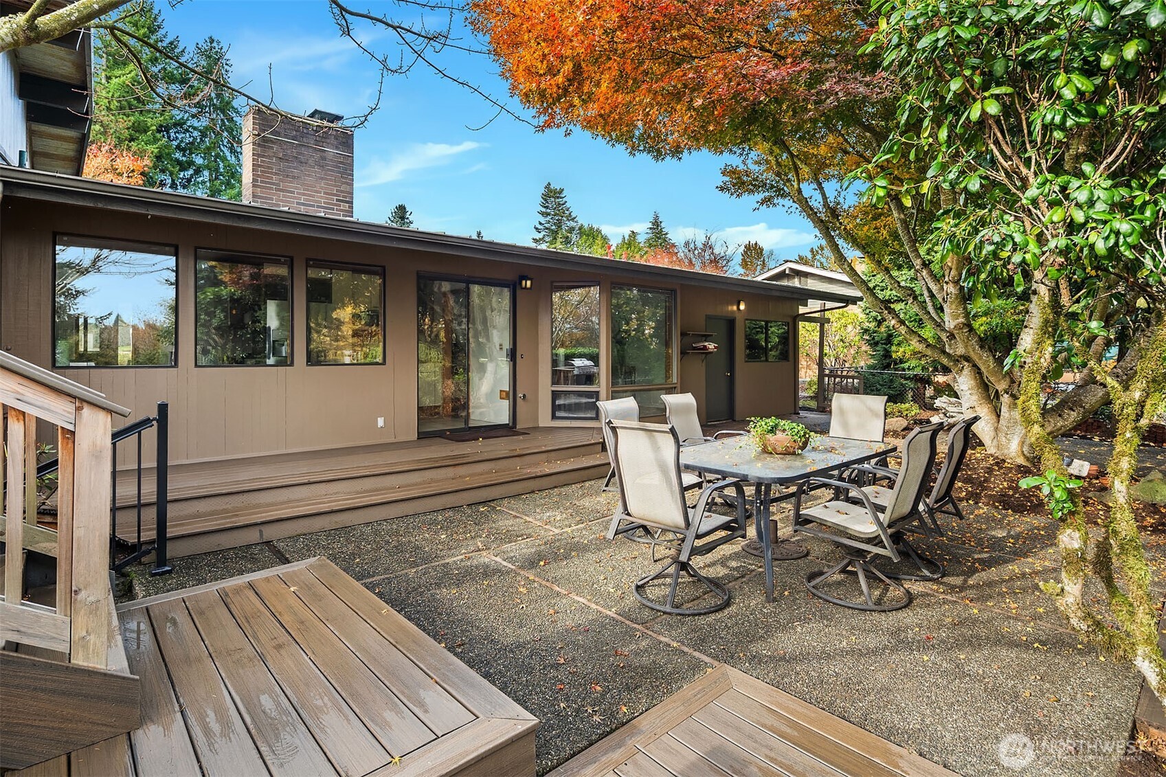 1718 128th Avenue Southeast Bellevue, WA 98005 - Photo 26 of 40 a view of a patio with table and chairs with wooden floor and fence