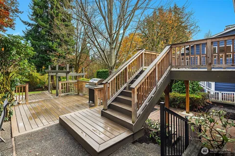a view of a house with backyard and deck
