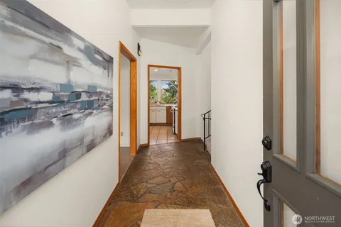 a view of a hallway with a dining area