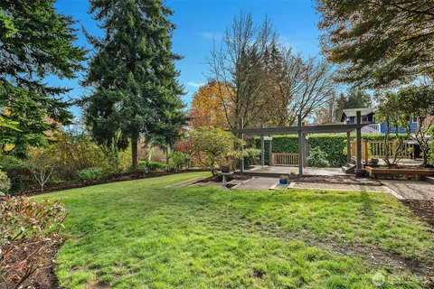 a view of a house with swimming pool and sitting area