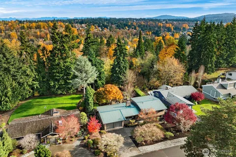 an aerial view of a house with a yard