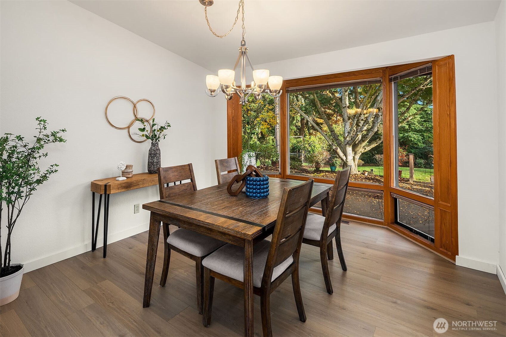 1718 128th Avenue Southeast Bellevue, WA 98005 - Photo 7 of 40 a dining room with furniture a large window and wooden floor