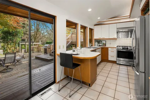 a kitchen with a sink stove and cabinets