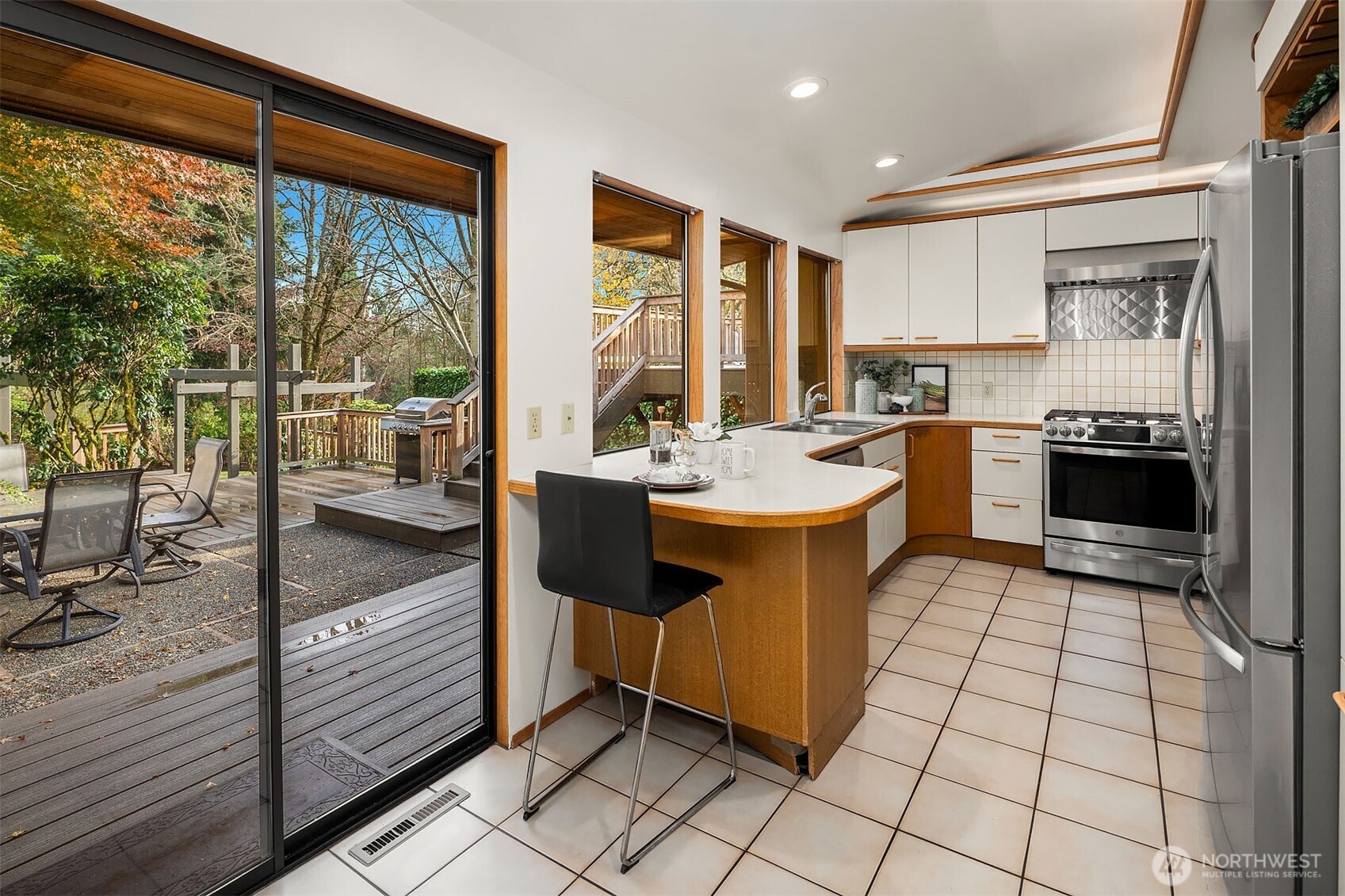 1718 128th Avenue Southeast Bellevue, WA 98005 - Photo 8 of 40 a kitchen with a sink stove and cabinets