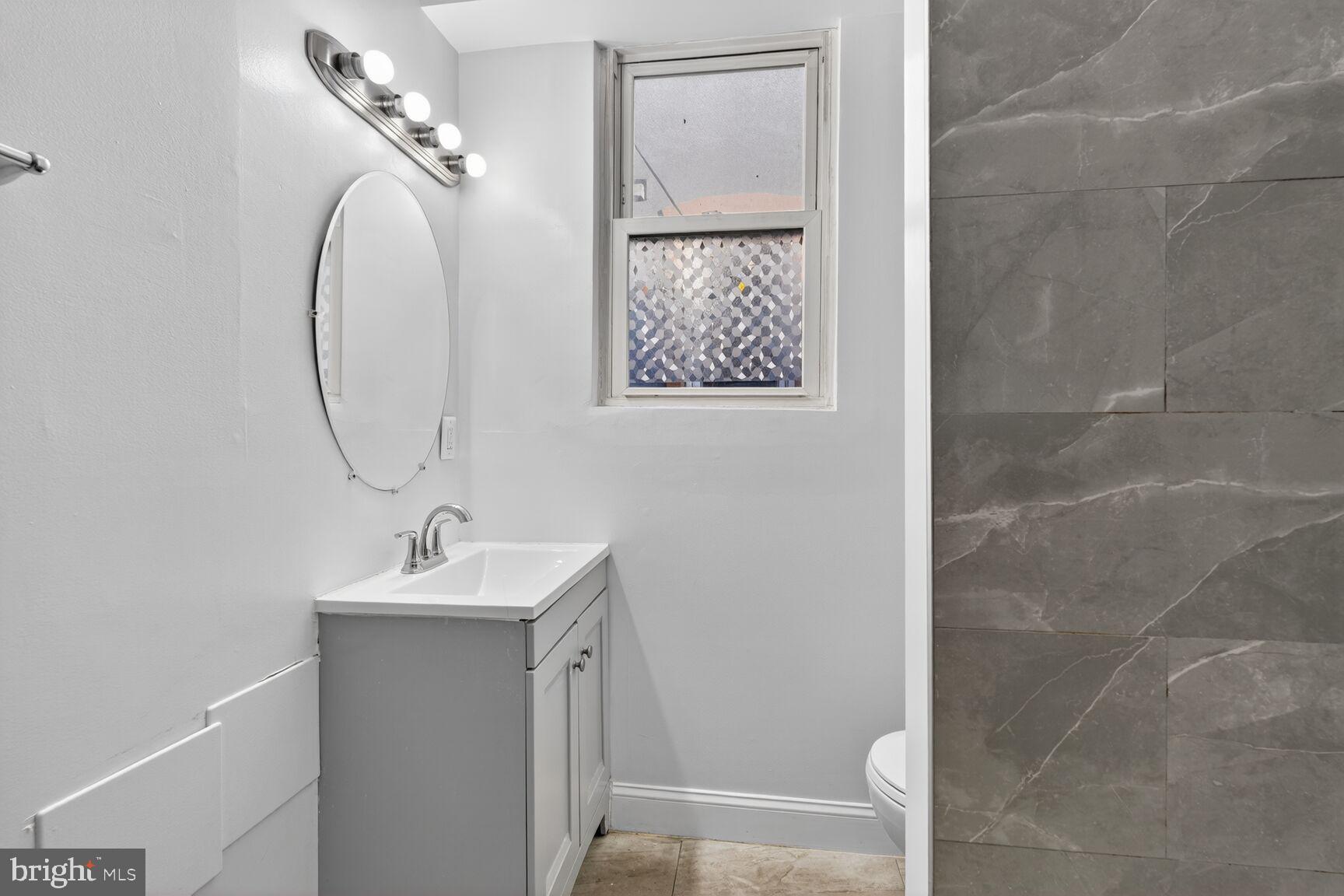 2409 18th Street Northwest, Unit 2 Washington, DC 20009 - Photo 12 of 19 a bathroom with a sink and a mirror