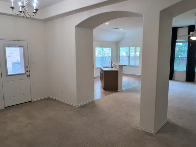 a kitchen with a stove top oven and refrigerator