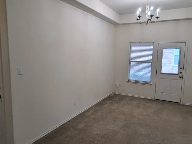 a kitchen with granite countertop a stove top oven microwave and cabinets