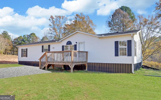 a view of a house with a backyard and a patio