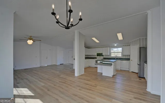 a view of a kitchen with a sink stainless steel appliances and cabinets