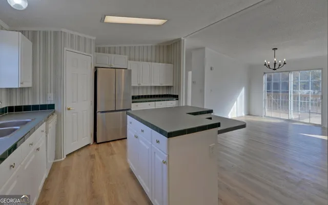 a kitchen with granite countertop a stove and a refrigerator
