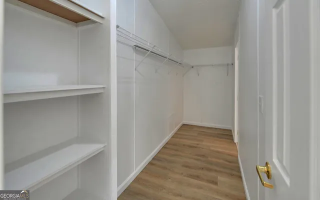 a view of hallway with wooden floor