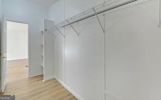 a view of a room with wooden floor