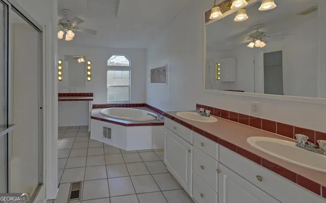 a bathroom with a sink a toilet a mirror and window