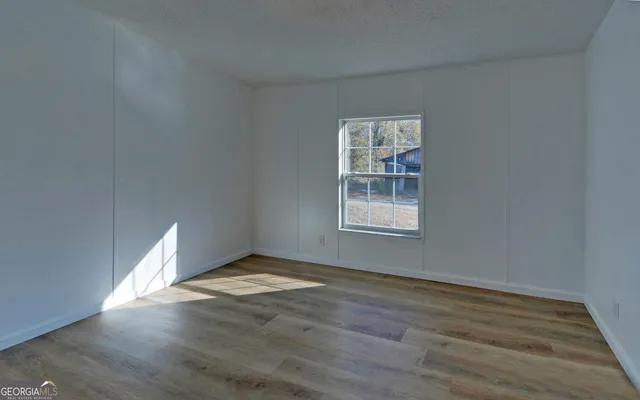 wooden floor in an empty room with a window