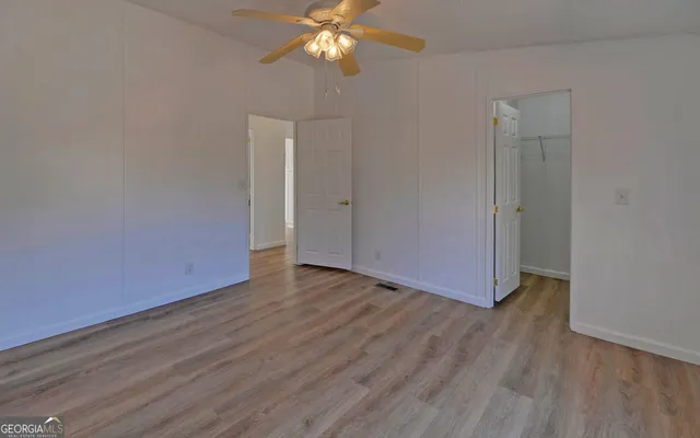 a view of an empty room with wooden floor