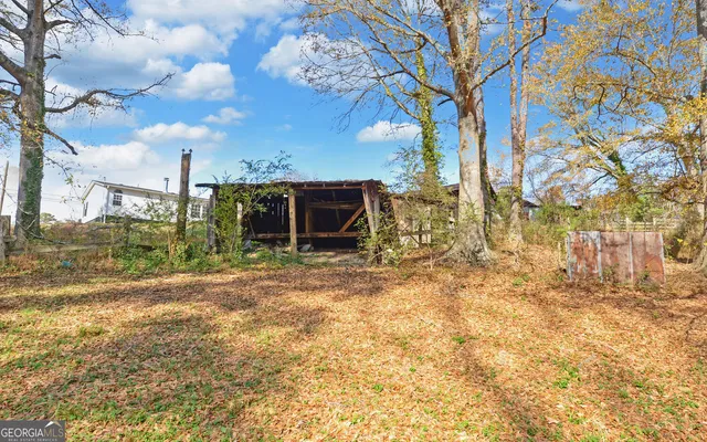 a view of a barn with wooden fence
