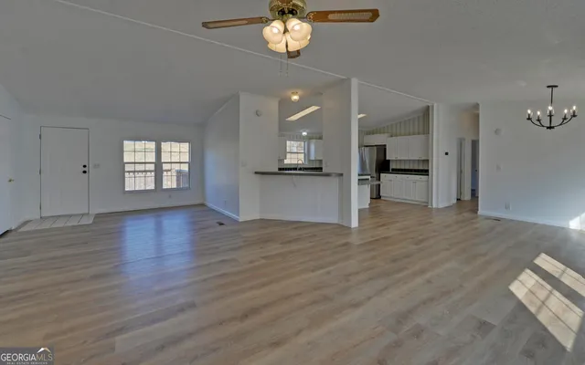a view of a kitchen with a dishwasher cabinets and wooden floor