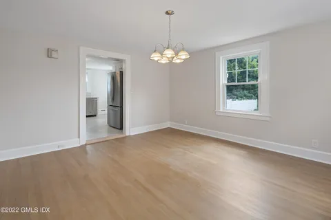 a kitchen with white cabinets and black appliances