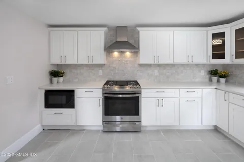 a kitchen with stainless steel appliances a stove sink and cabinets