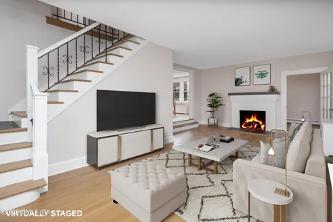 a living room with furniture a flat screen tv and a fireplace