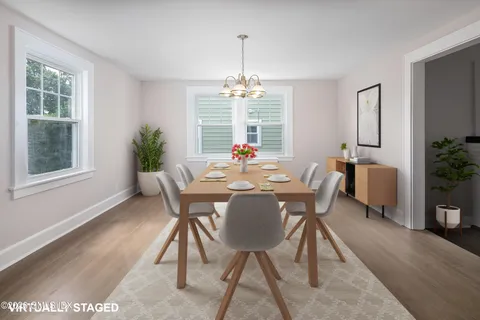 a view of wooden floor and chandelier in living room