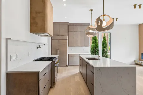 a view of cabinets and utility room with racks on the wall