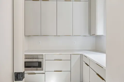 an empty room with windows and entrance