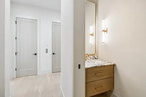 a bathroom with a double vanity sink and a mirror