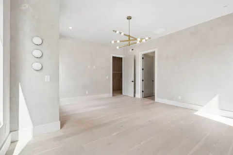 a view of an empty room with window and cabinet