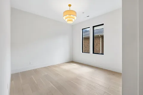 a view of a livingroom with wooden floor and a window