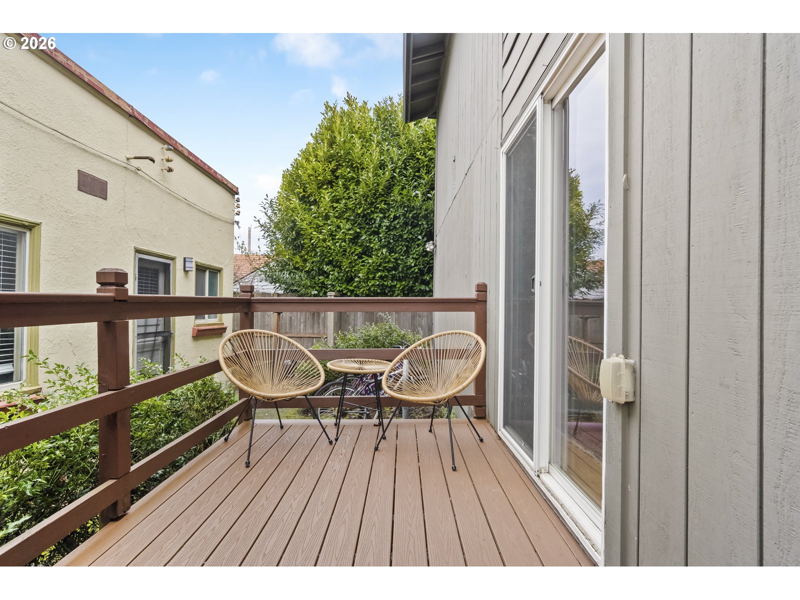 2301 Southeast Caruthers Street, Unit 1 Portland, OR 97214 - Photo 11 of 18 a balcony with wooden floor table and chairs