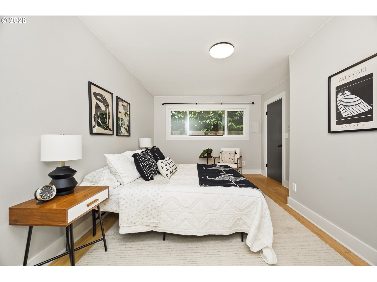 2301 Southeast Caruthers Street, Unit 1 Portland, OR 97214 - Photo 12 of 18 a bedroom with furniture and a window