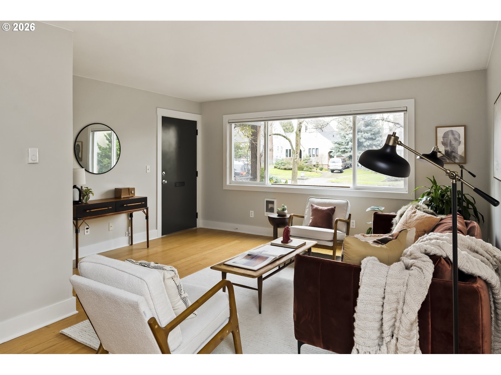 2301 Southeast Caruthers Street, Unit 1 Portland, OR 97214 - Photo 3 of 18 a living room with furniture a window and a clock
