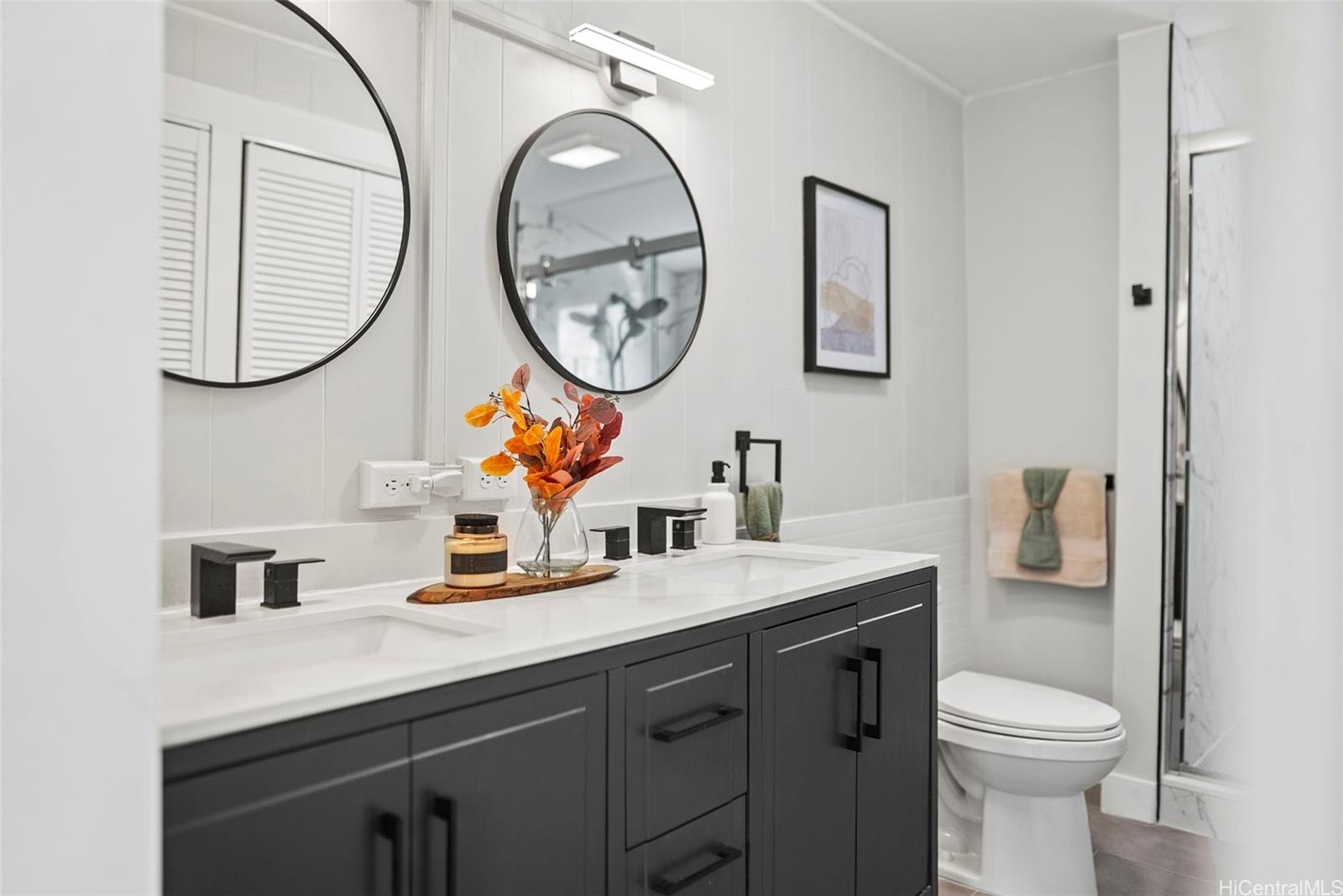 809 Hao Street Honolulu, HI 96821 - Photo 19 of 25 a bathroom with a toilet a sink and a mirror