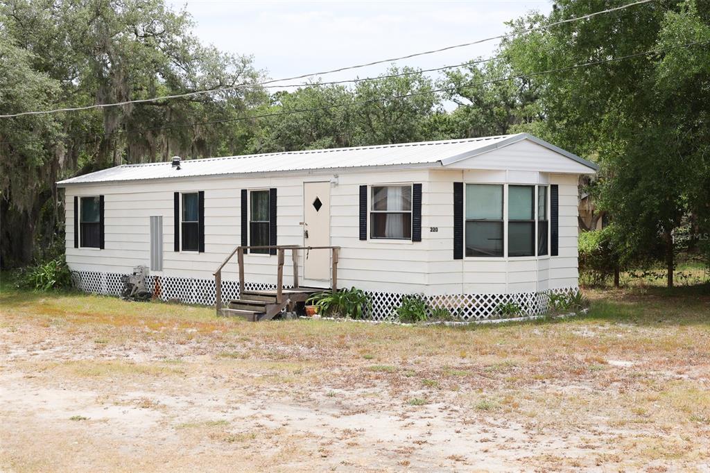 220 King Road Southwest Winter Haven, FL 33880 - Photo 1 of 18 a front view of a house with a garden