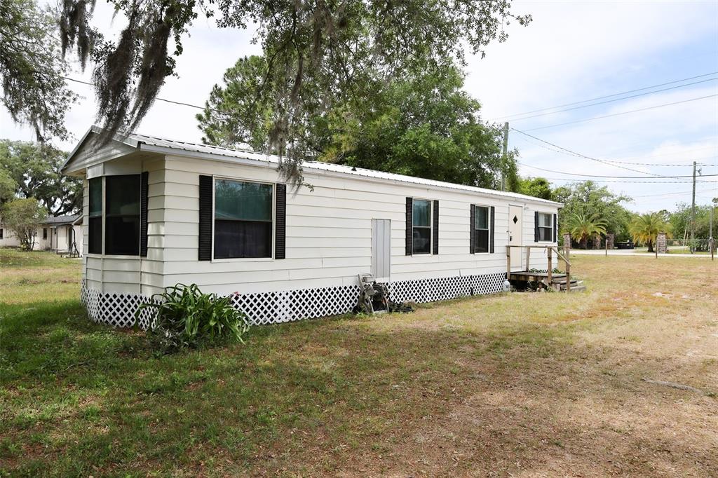 220 King Road Southwest Winter Haven, FL 33880 - Photo 2 of 18 a front view of a house with a garden