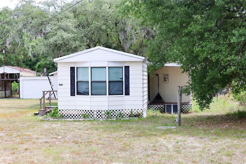 220 King Road Southwest Winter Haven, FL 33880 - Photo 5 of 18 a front view of a house with garden