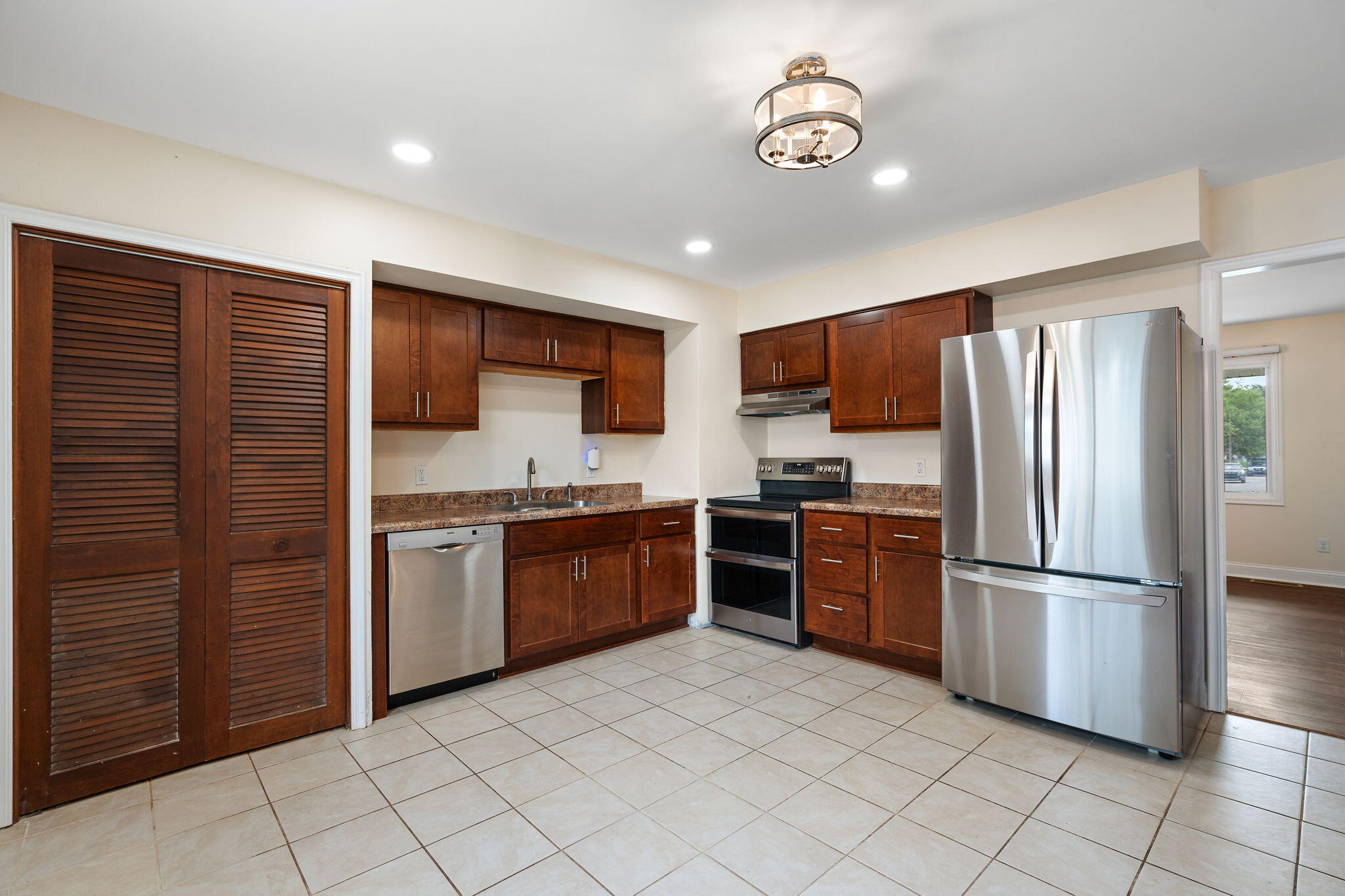 385 Riviera Court Valparaiso, IN 46385 - Photo 11 of 27 a kitchen with stainless steel appliances granite countertop a refrigerator and a stove top oven